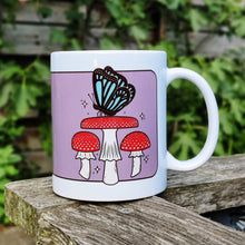 Laden Sie das Bild in den Galerie-Viewer, Blue Butterfly with Fly Agaric Mushrooms | Mushroom Pals | Ceramic Mug - Scaredy Cat Studio

